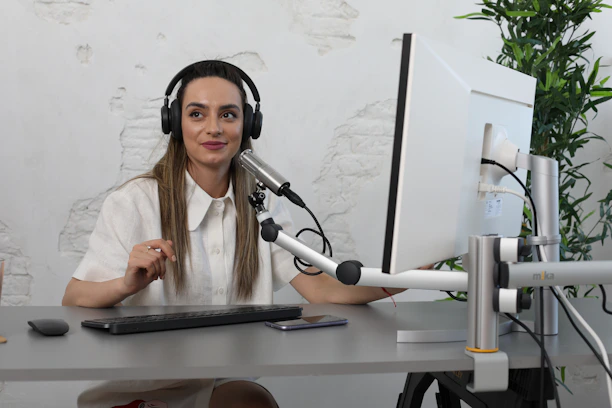 Close-up of a confident woman attending an online digital marketing class with headphones on.