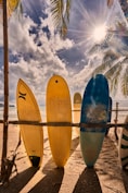 a group of surfboards on a beach