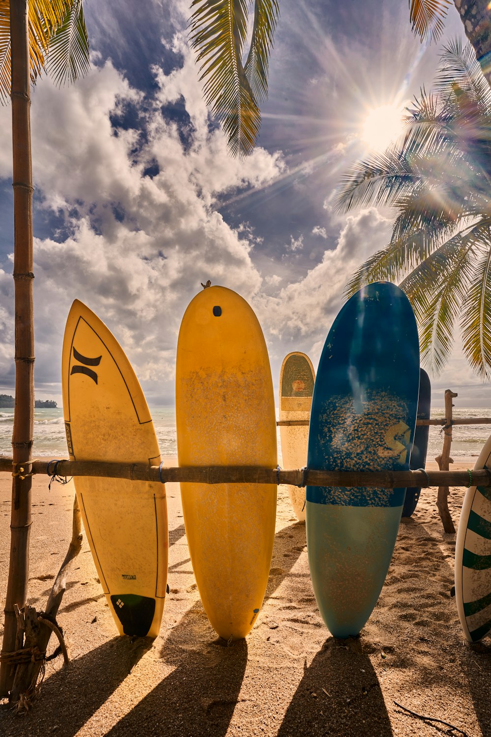 a group of surfboards on a beach