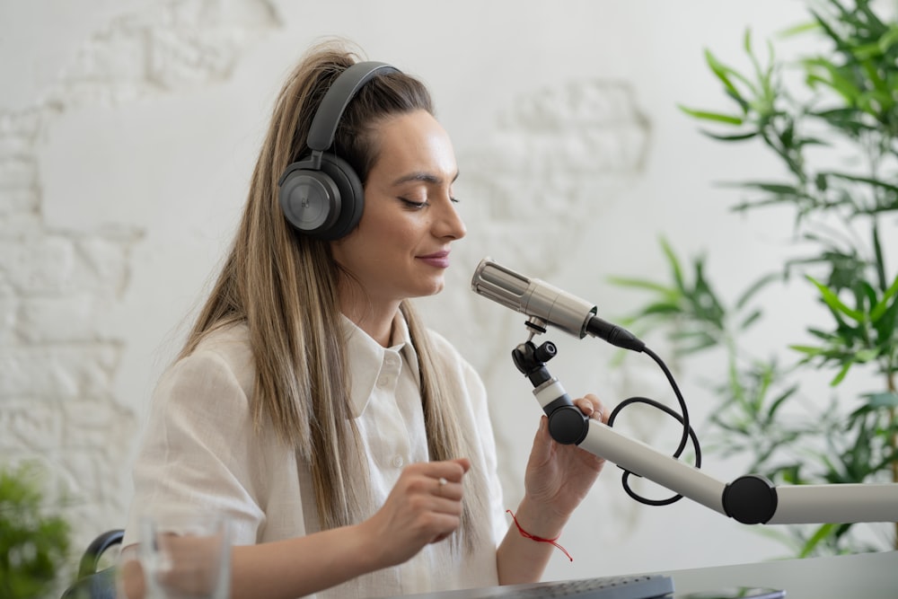 a woman wearing headphones and holding a microphone