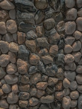 A close-up of smooth, colorful stones arranged on a natural surface.
