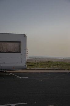 A premium motorhome parked near a sunny beach in Costa del Sol.