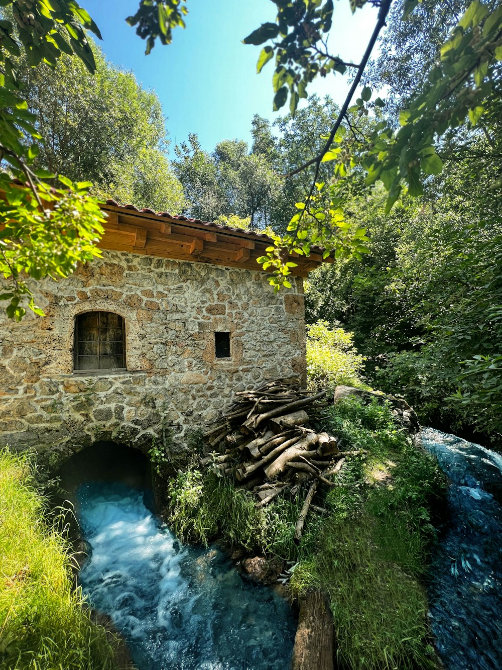 a stone building with a waterfall