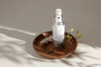 A serene post-shower routine scene with a mist bottle on a wooden shelf next to a towel.
