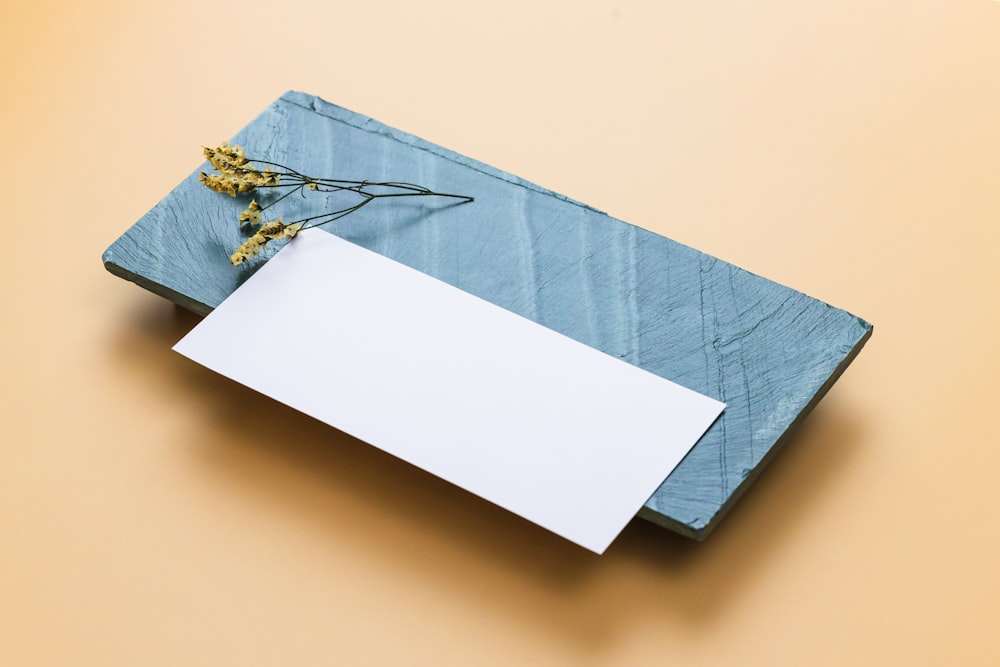 a blue paper with a metal hook