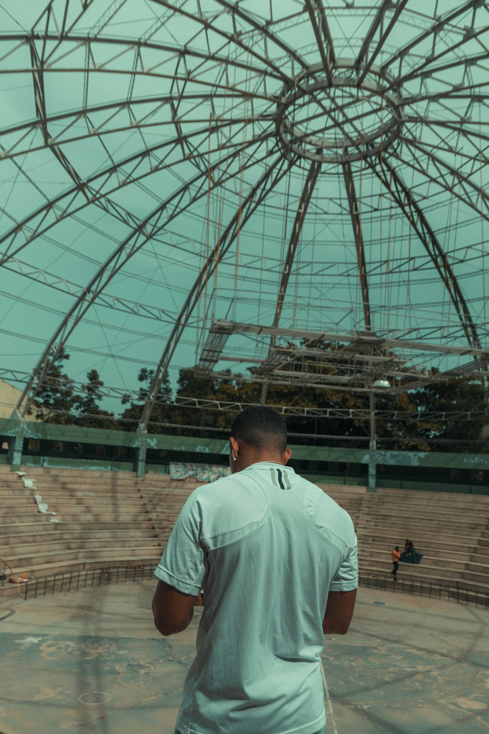 a man looking at a large glass dome