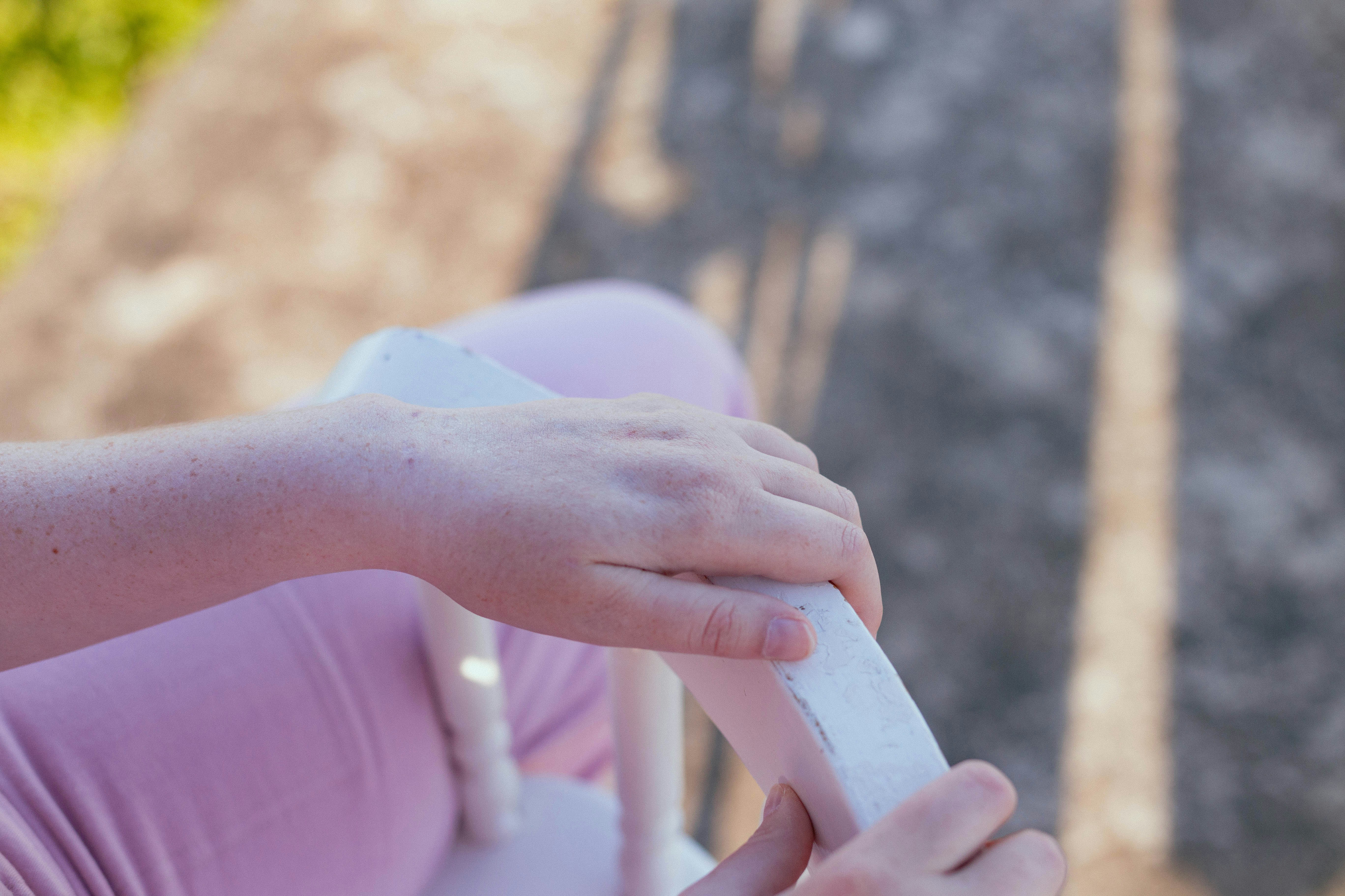 A person holding a knocked-out tooth in a small container of milk - dental emergency room near me