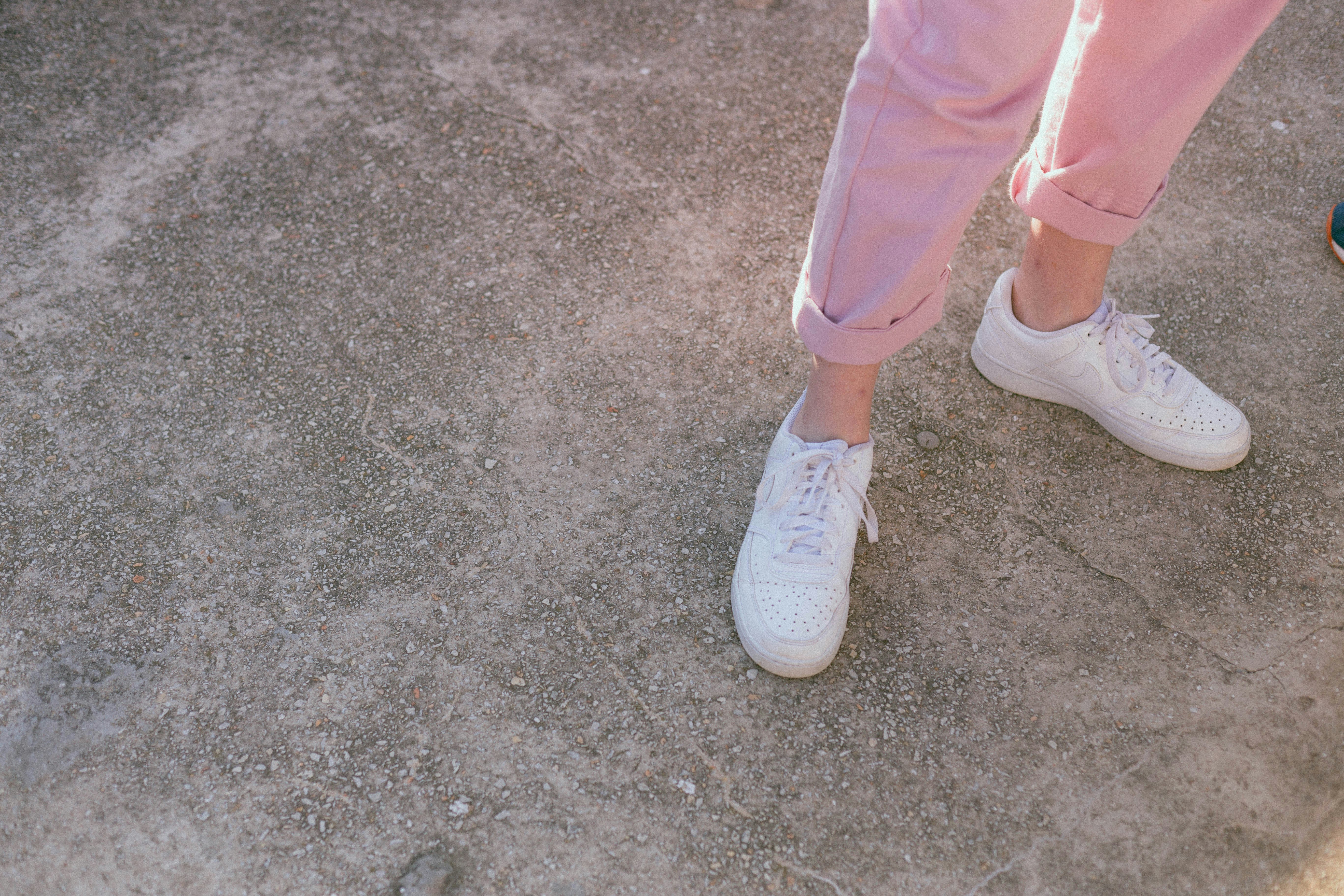 a pair of feet with white shoes
