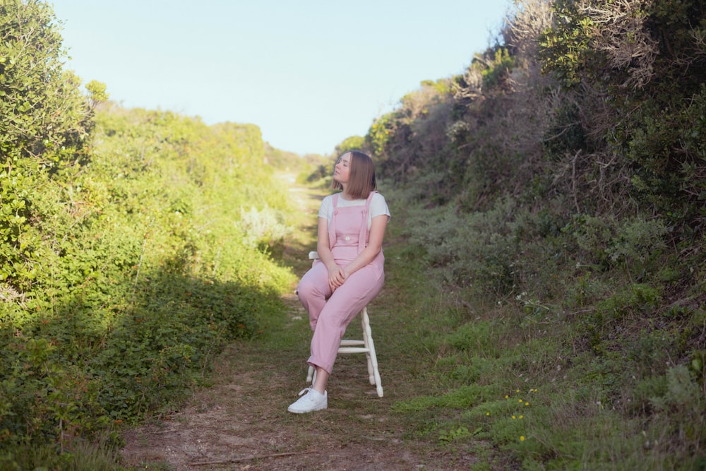 a person sitting on a chair outside