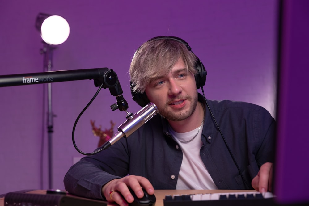 a person wearing headphones and sitting at a piano