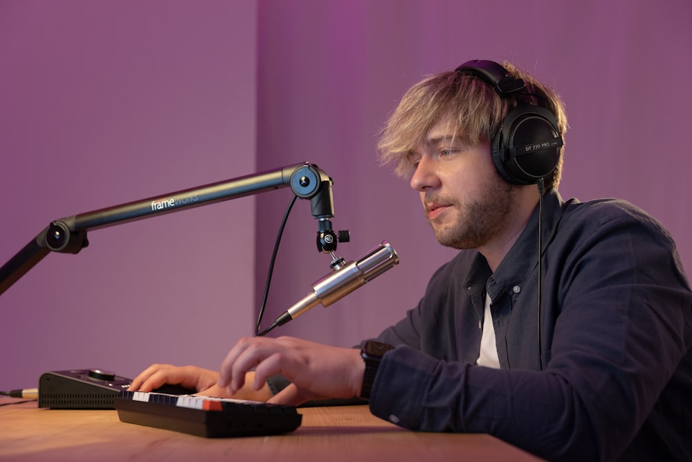 a man wearing headphones and playing a keyboard