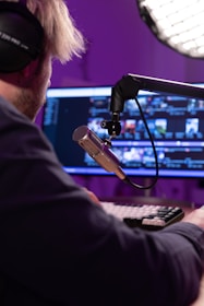 a man with headphones on playing a keyboard