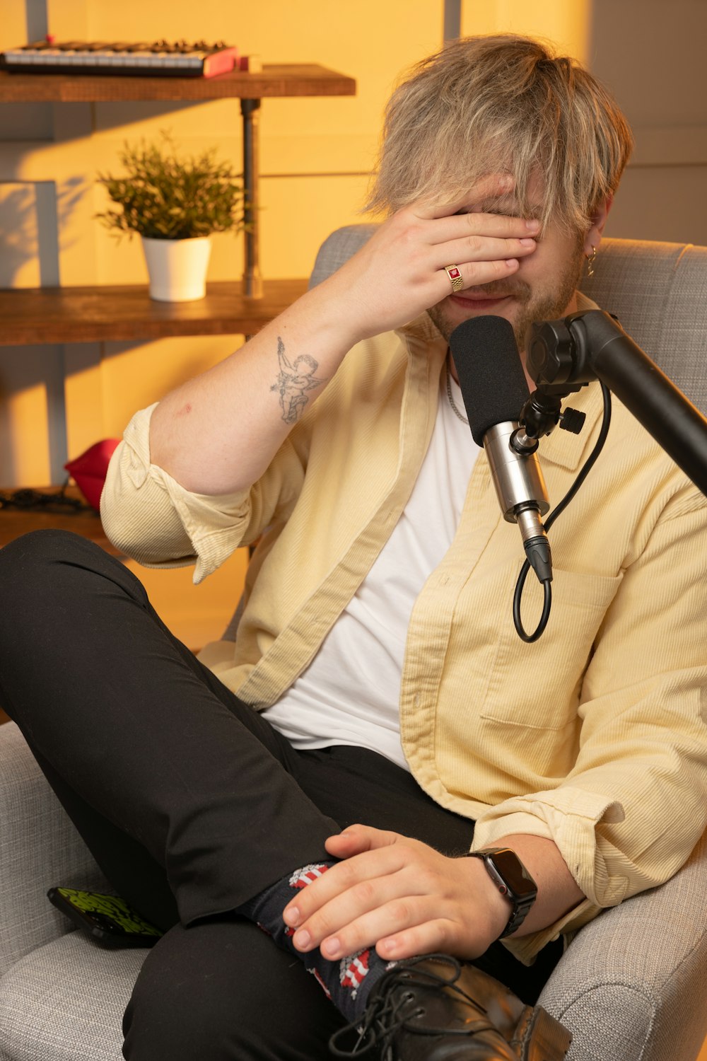 a person sitting on a couch with the hands on the face