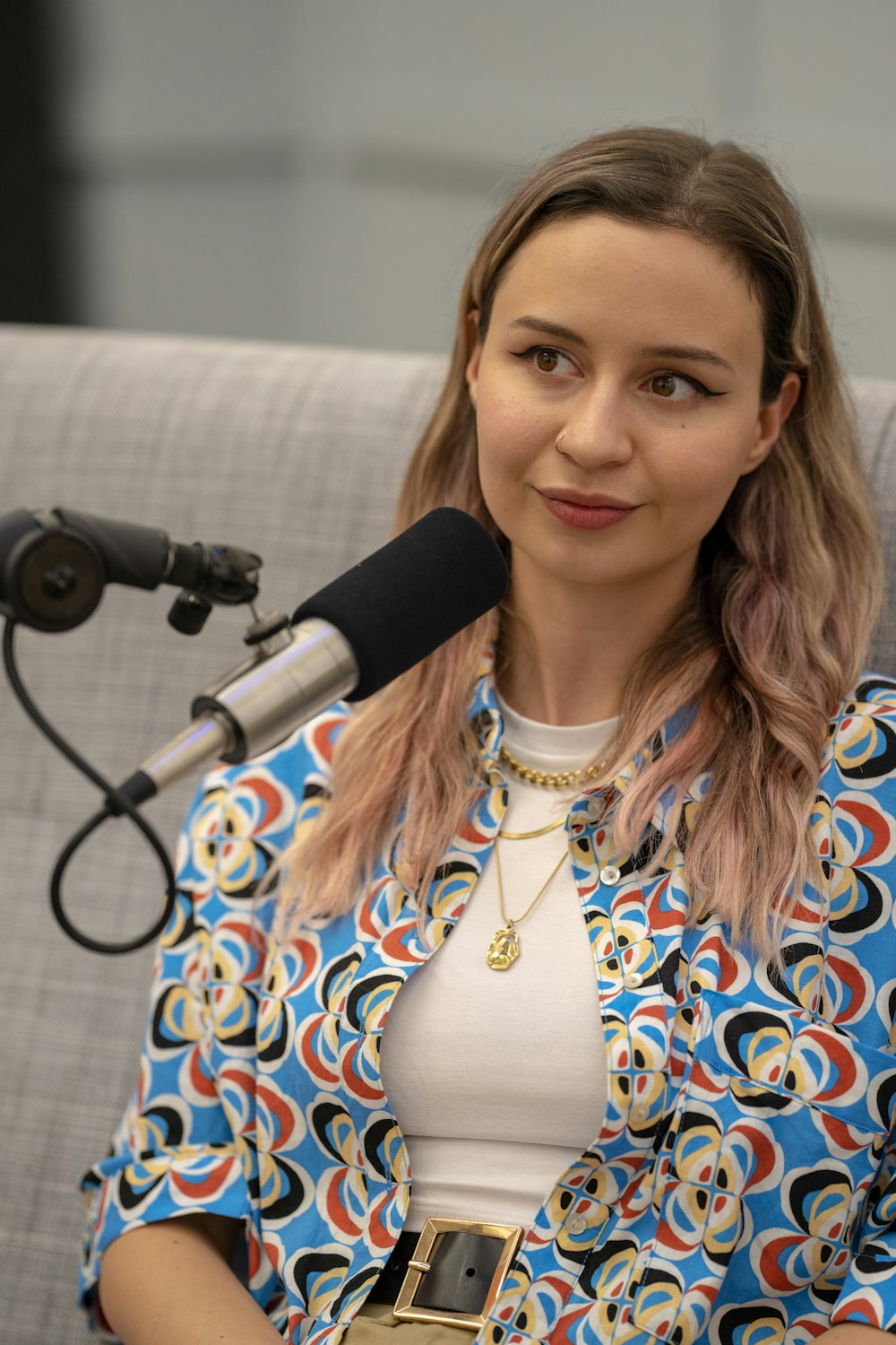 a woman sitting at a microphone