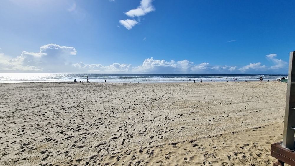 a beach with people walking on it