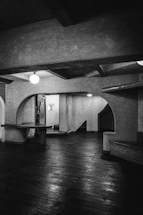 A dimly lit architectural space with warm shadows and minimal design.