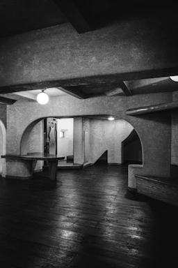 A dimly lit architectural space with warm shadows and minimal design.