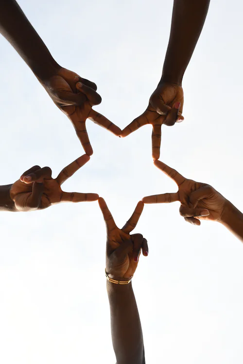 Chama Management System — People joining hands in a community setting