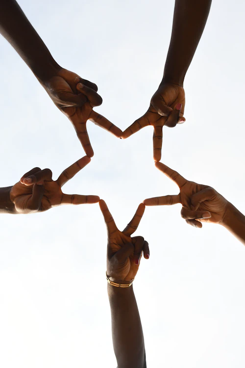 A group of people holding hands in community