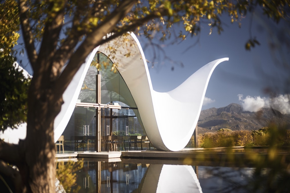 a white tent by a lake