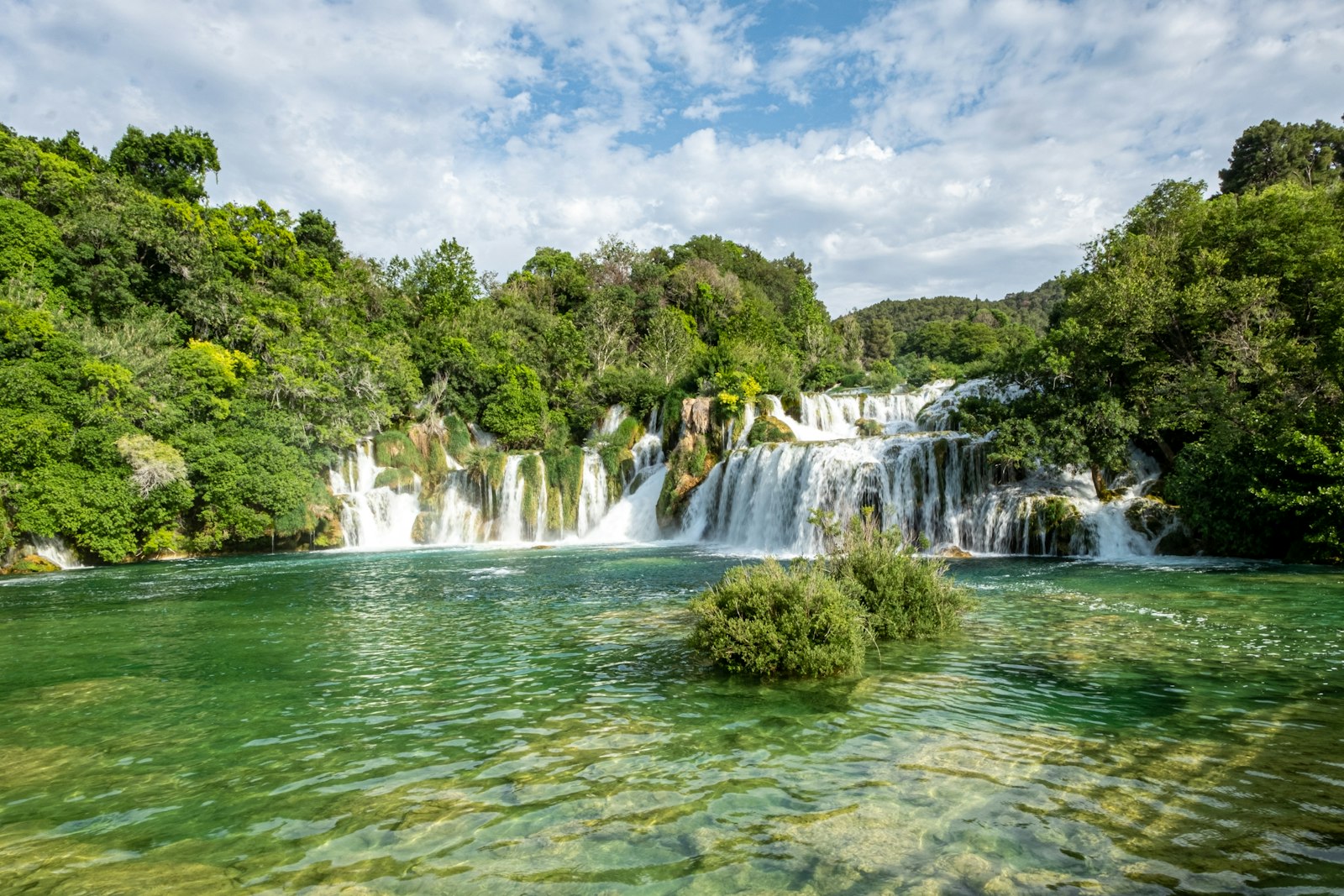 The broad, tiered cascades of Skradinski buk in Krka National Park, framed by green forest and clear water