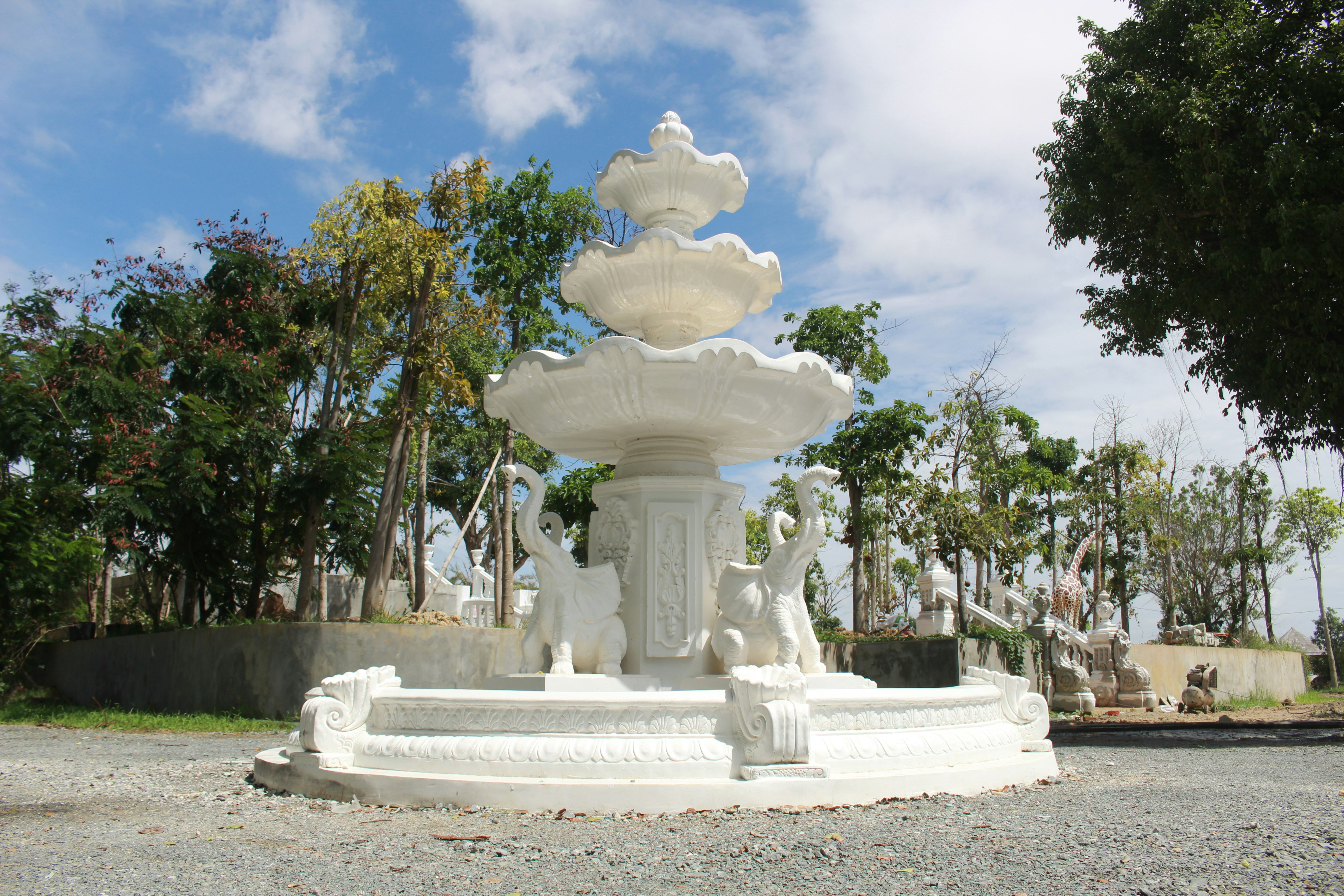 a statue of a person with a lion on a pedestal in a park
