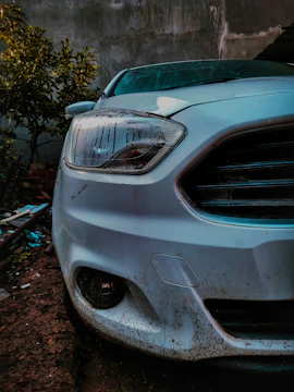 Close-up of a dusty, muddy car exterior before cleaning.