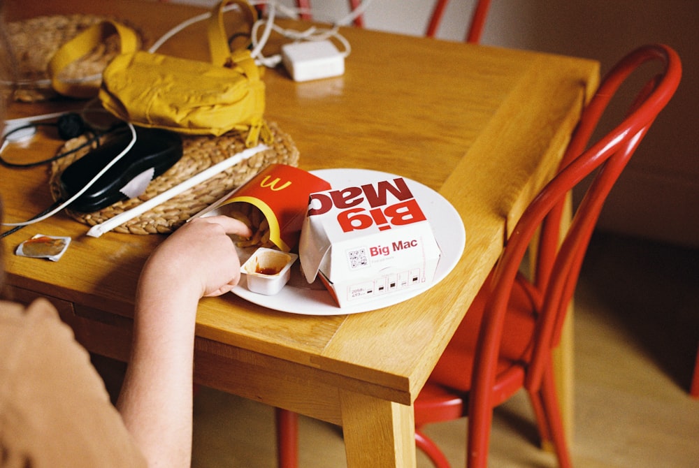 a person holding a box of cookies