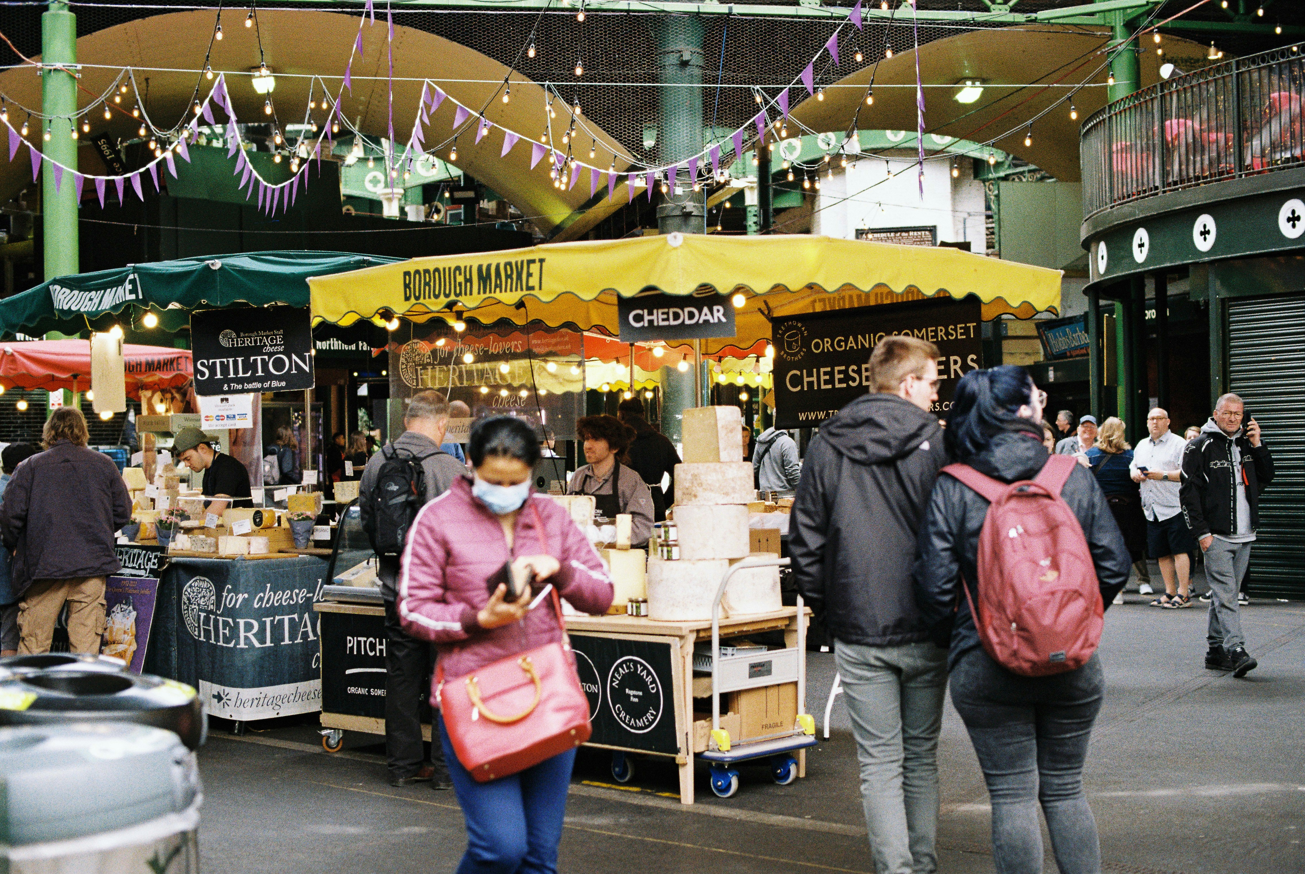people walking near a food stand