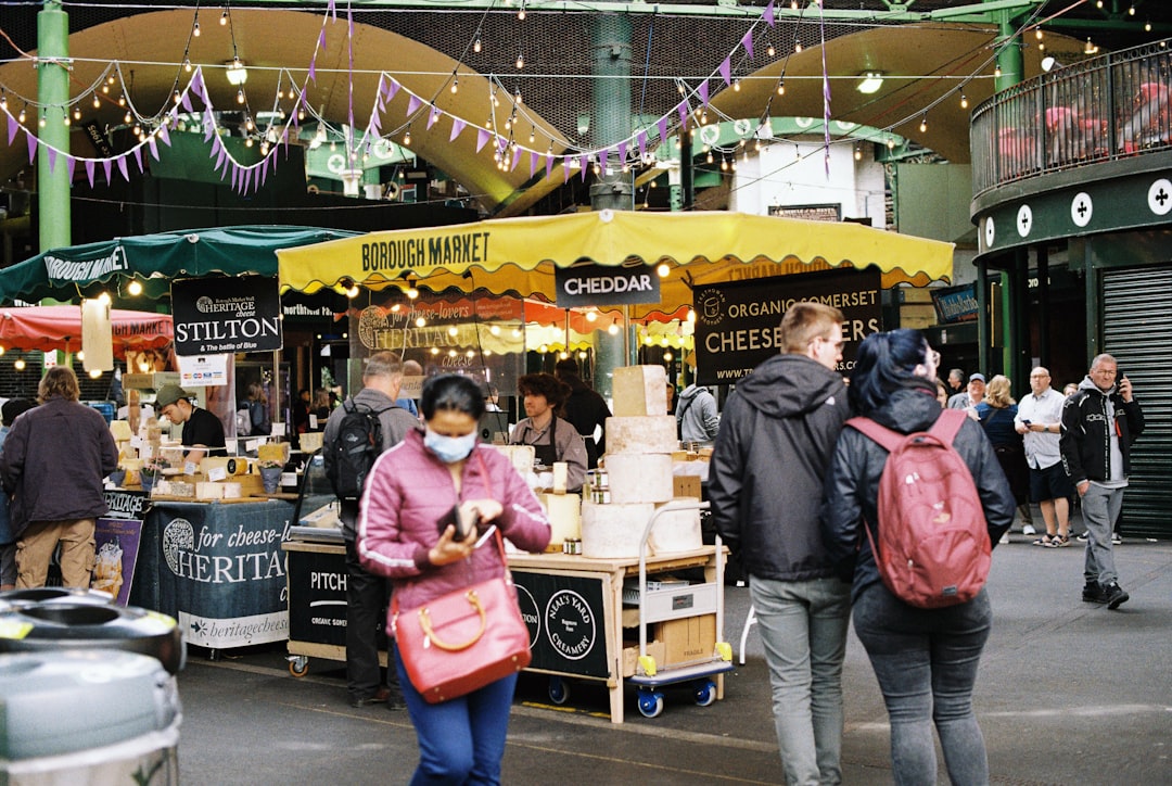 people walking near a food stand,