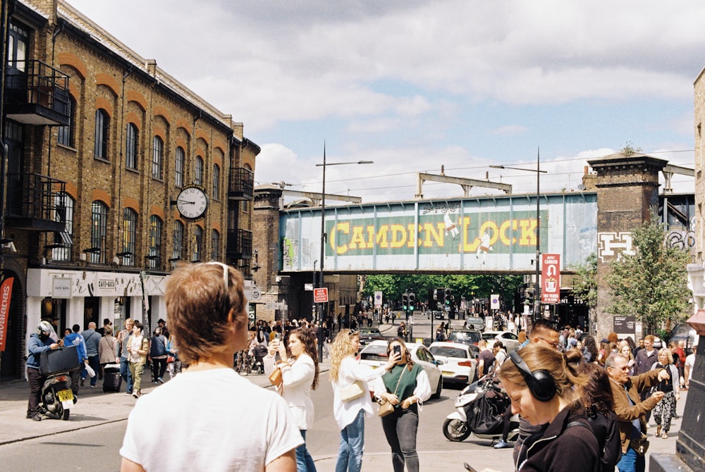 a crowd of people walking on a busy street