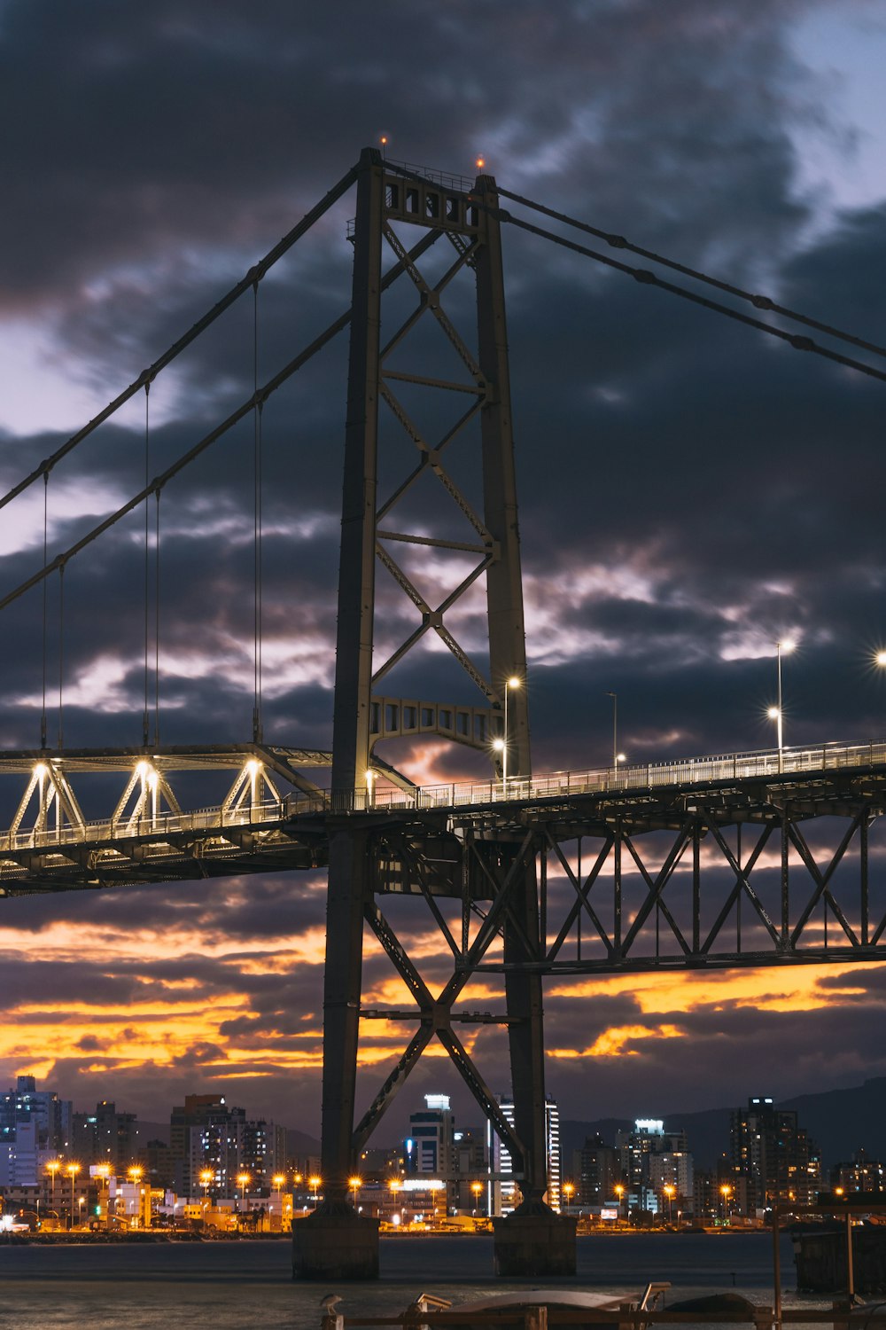 uma ponte sobre a água com uma cidade ao fundo