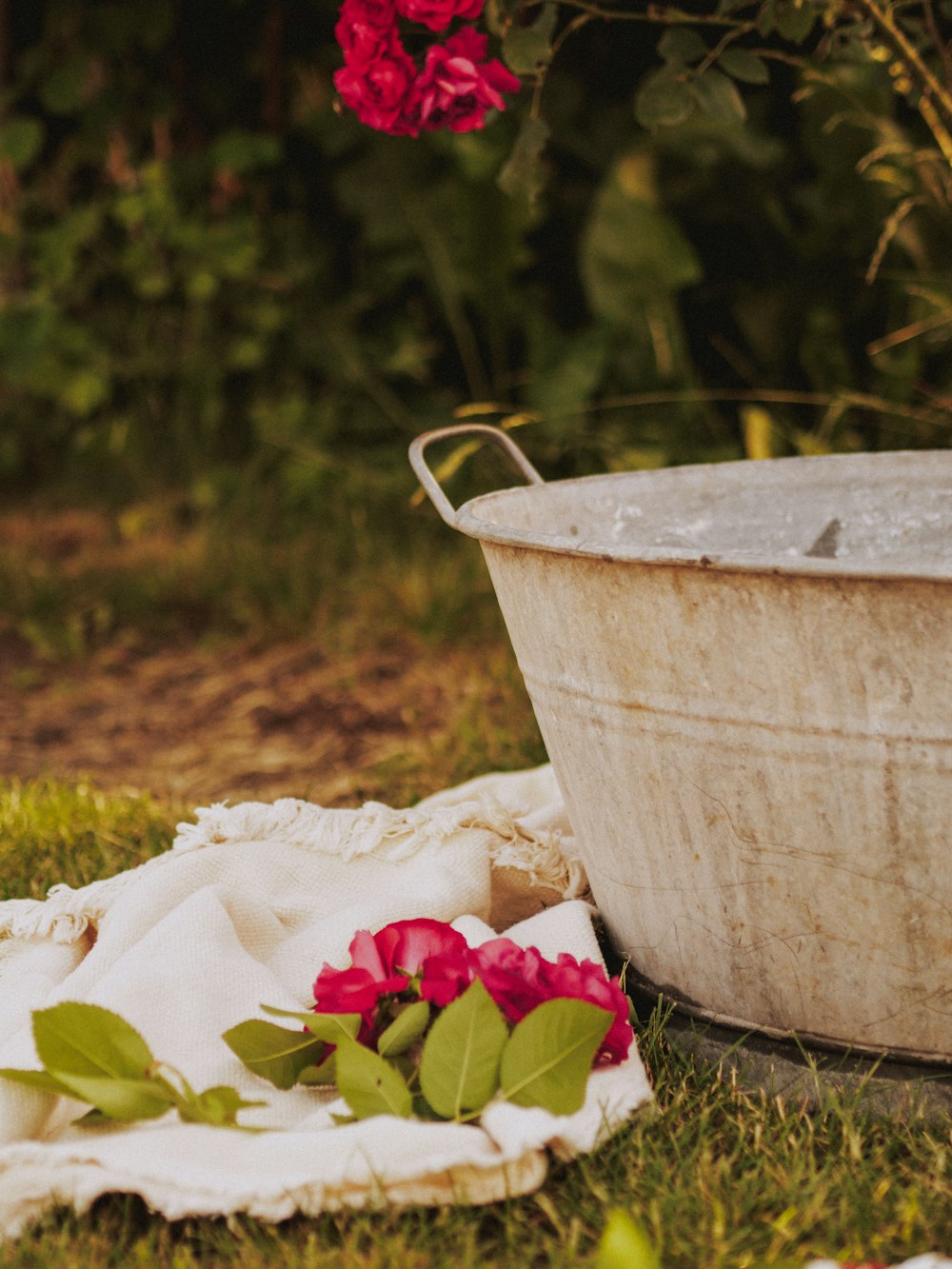 a white bucket with flowers in it