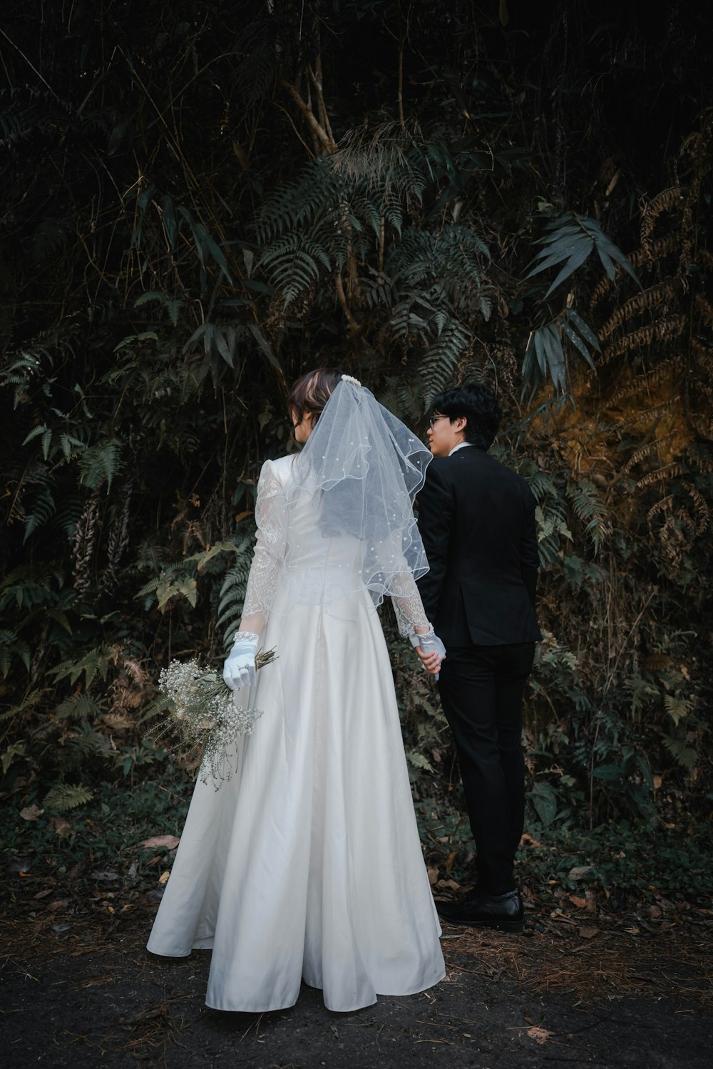 a man and woman in wedding attire