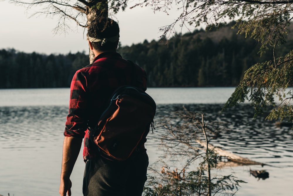 a man standing in front of a lake