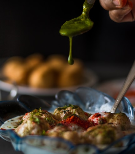 a person holding a green pepper