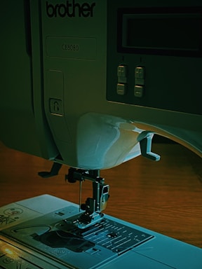 Close-up of a computerized sewing machine control panel with digital display.