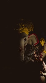 A serene image of a glowing Lalitha Tripura Sundari statue surrounded by soft candlelight.