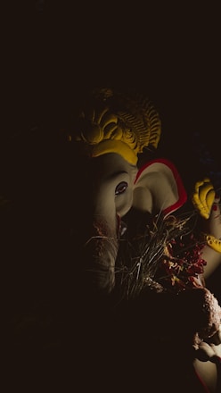 A serene image of a glowing Lalitha Tripura Sundari statue surrounded by soft candlelight.