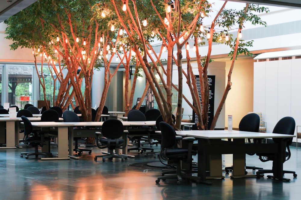 a room with tables and chairs and trees