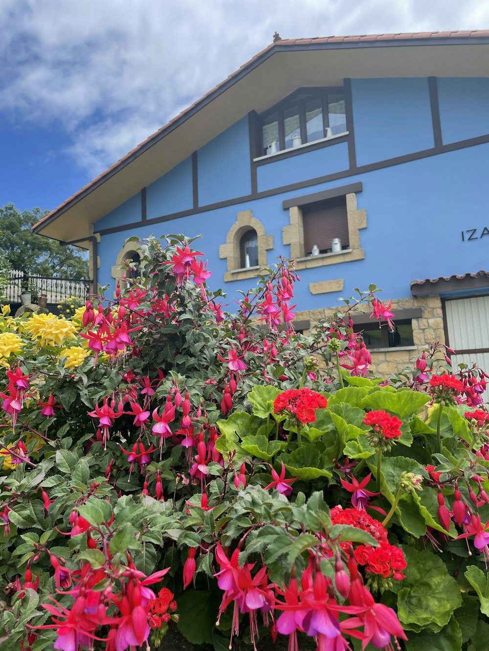 a building with many flowers in front of it