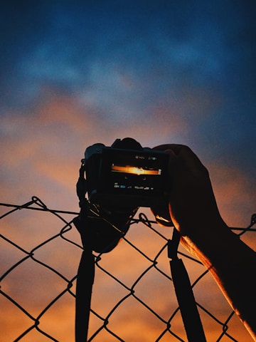 A cinematic portrait of Enrique Blein Gerstl behind the camera, capturing a vibrant Miami sunset.
