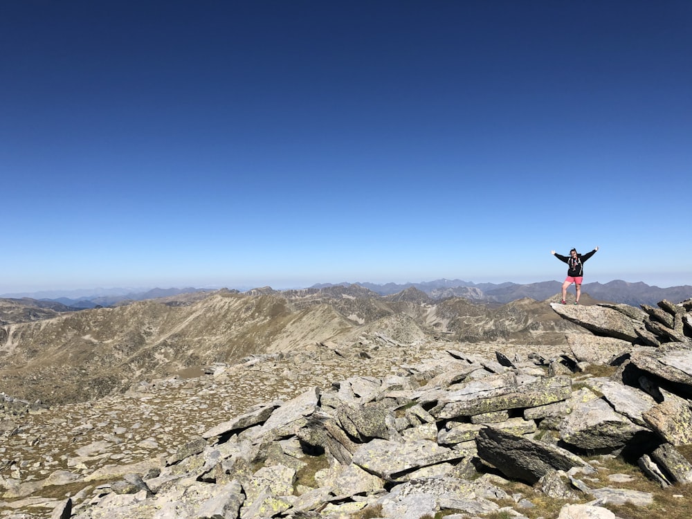 a person standing on a rocky area