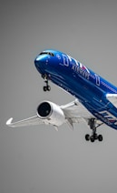 a blue and white airplane flying