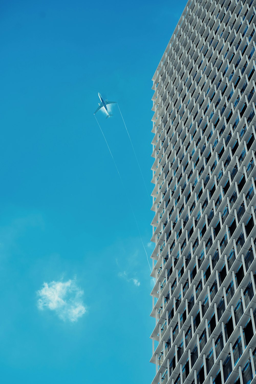 a jet flying over a skyscraper