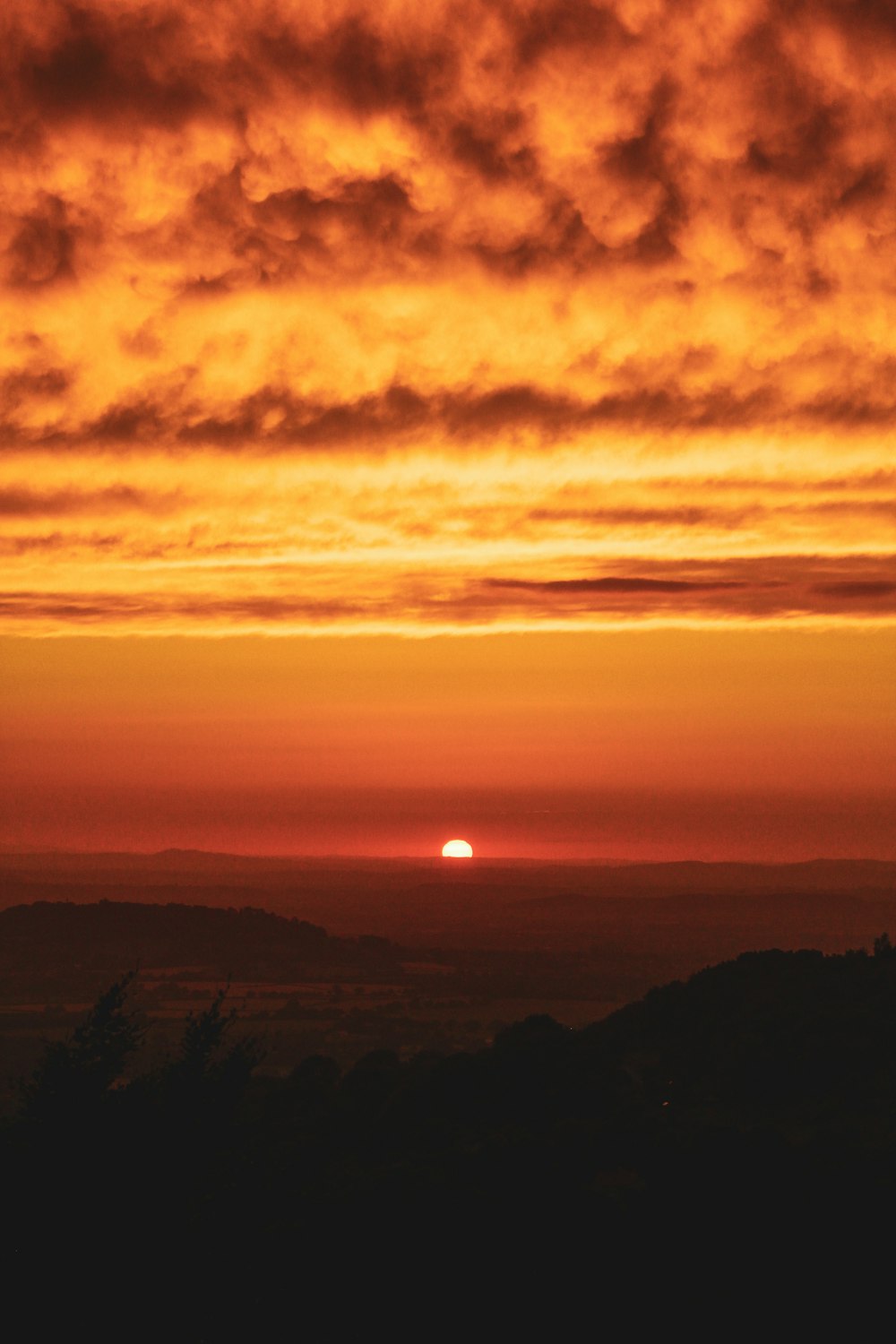 a sunset over a mountain range