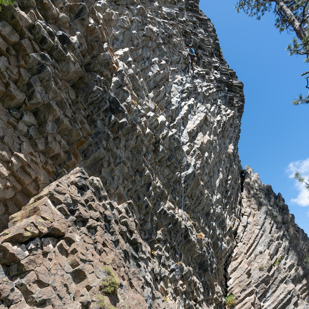 a rocky cliff with a person on it