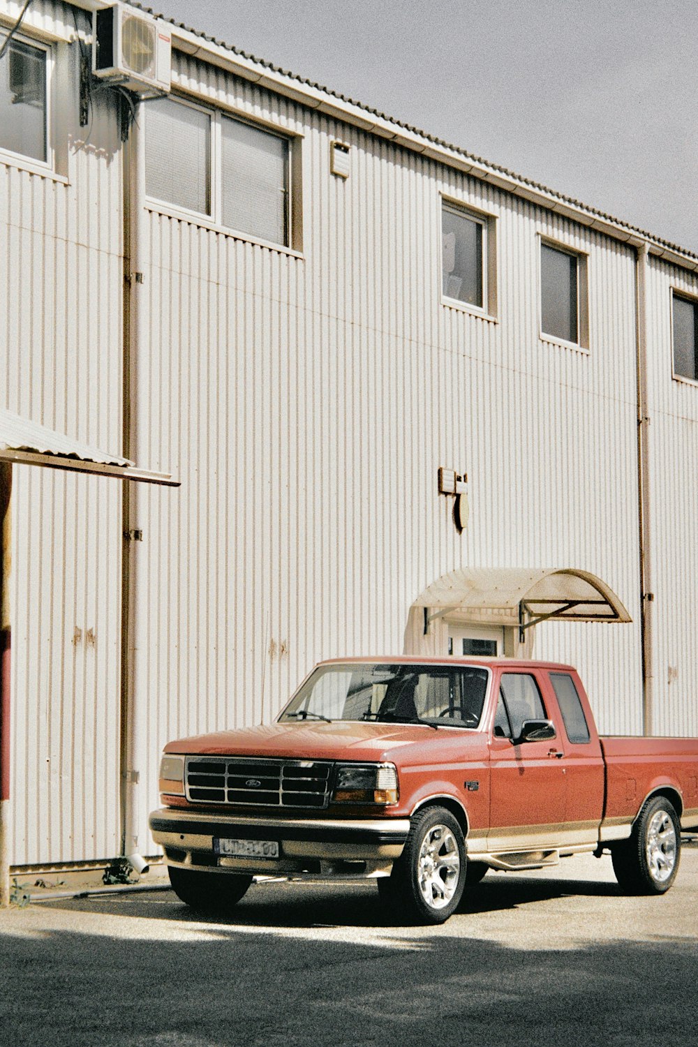 a red truck parked in front of a white building