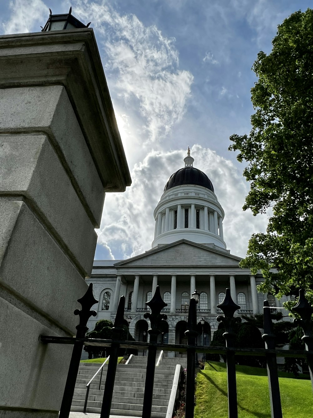 a white building with a black gate