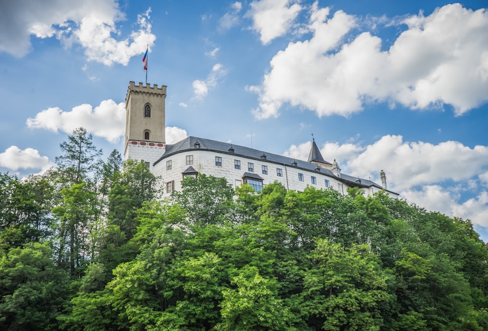 a building with a tower surrounded by trees